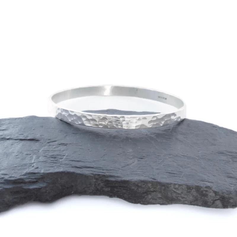 Sterling silver bangle with dimple texture. Available in 4 sizes.