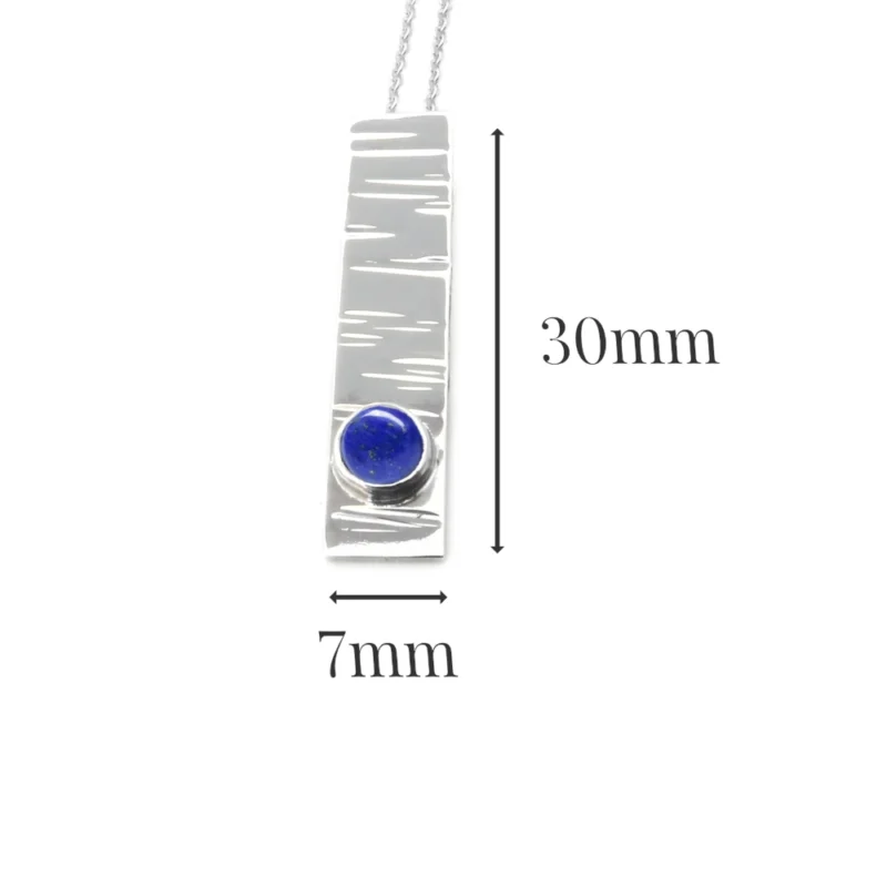 Sterling silver and 5mm Lapis Lazuli pendant featuring the bark texture. This pendant comes complete with a 16-18″ sterling silver chain.