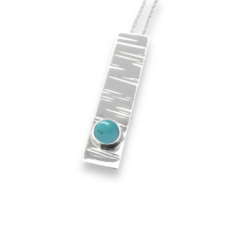 Sterling silver and 5mm Turquoise pendant featuring the bark texture. This pendant comes complete with a 16-18″ sterling silver chain.