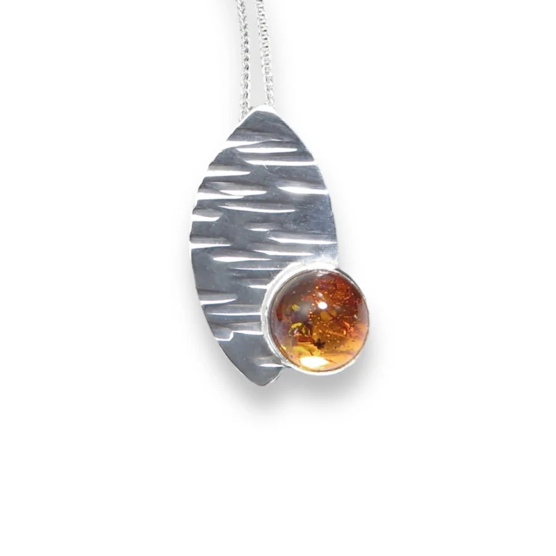 Sterling silver and 10mm Amber pendant featuring the bark texture. This pendant comes complete with a 16-18″ sterling silver chain.