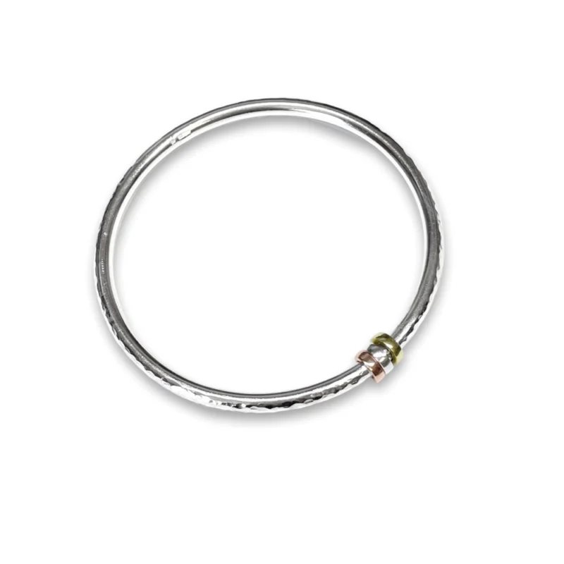 Sterling silver bangle with Brass, Silver and Copper charms. Available in 4 sizes.