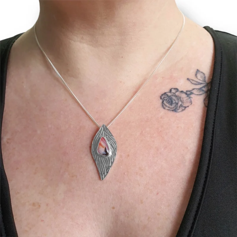 pink opal silver pendant worn