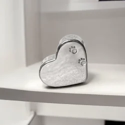 Sterling silver heart memorial box with paw prints stamped on front.
